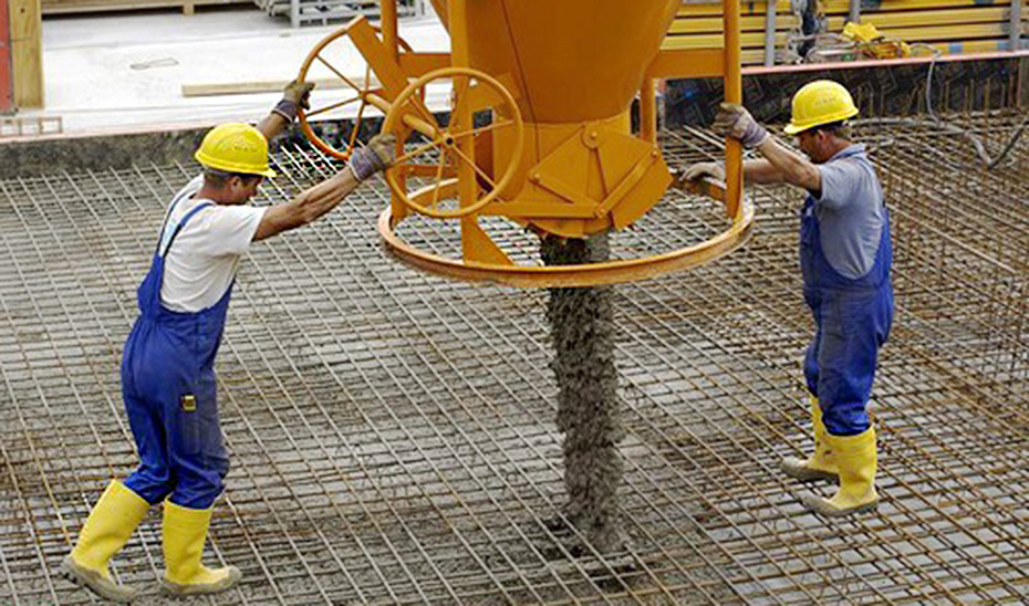 Obreros de la construcción completando un proceso de cimentación.