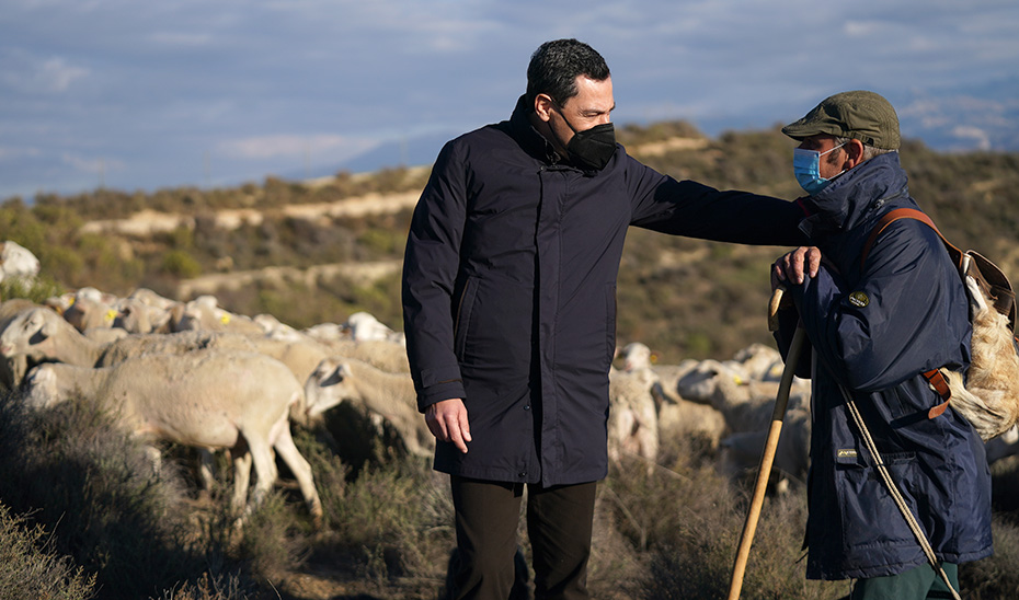 Juanma Moreno conversa con un ganadero en Las Gabias (Granada).